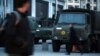 Outside Brussels’ central train station, commuters hurry toward their homes as the military guards the area, March 24, 2016. (H. Murdock/VOA)