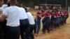 FILE - Indian army women recruits compete with men in a tug-of-war as part of their training before they are inducted as the first women soldiers below officer rank, during a media visit in Bengaluru, India.