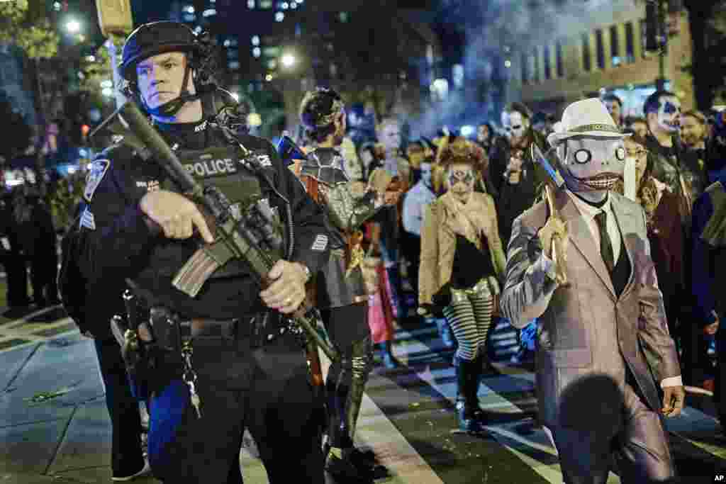 Heavily armed police guard the Greenwich Village Halloween Parade in New York, Oct. 31, 2017. New York City's always-surreal Halloween parade marched on Tuesday evening under the shadow of real fear, hours after a truck attack killed several people on a busy city bike path in what authorities called an act of terror.