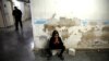 A relative of a wounded fighter waits for the end of his surgery in a hospital in Idlib, Syria, Feb. 28, 2020. 