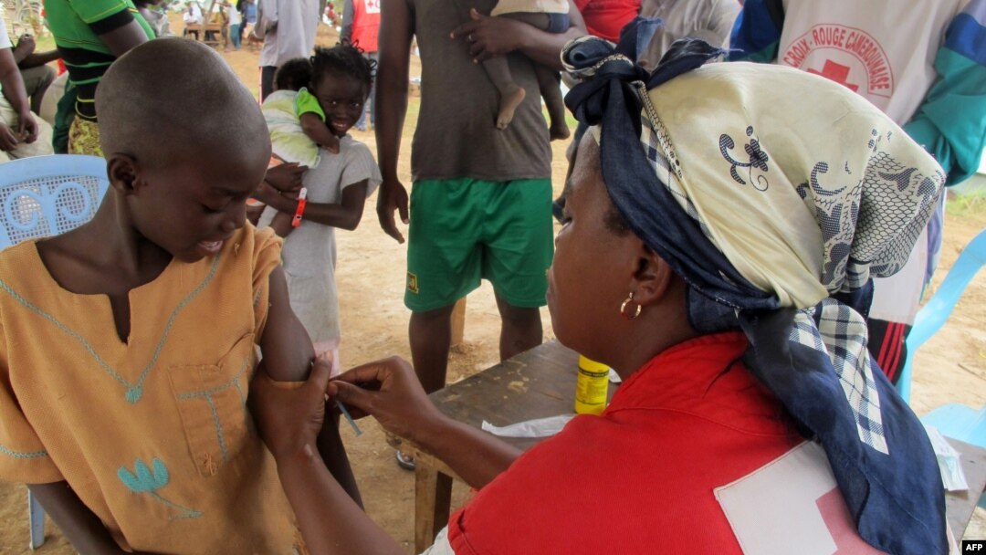 FILE - A child receives a measles vaccine in Nangungue, eastern Cameroon, April 12, 2013.