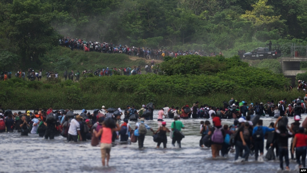 Salvadorean migrants heading in a caravan to the US, cross the Suchiate River to Mexico, as seen from Ciudad Tecun Uman, Guatemala, Nov. 2, 2018.