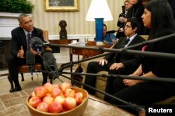 FILE - Then-President Barack Obama meets with a group of "Dreamers" affected by the Deferred Action for Childhood Arrivals program at the White House in Washington, Feb. 4, 2015.