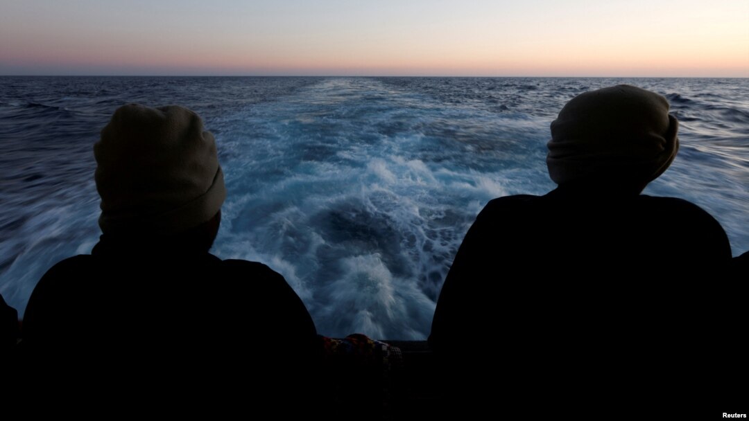 FILE - Rescued migrants look out to sea on the Geo Barents rescue ship, operated by Medecins Sans Frontieres (Doctors Without Borders), as the ship makes its way to the Italian port of Bari, in the central Mediterranean Sea, March 25, 2023.