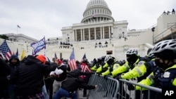 FILE - In this Wednesday, Jan. 6, 2021 file photo, Trump supporters try to break through a police barrier at the Capitol in Washington. The House committee investigating the violent Jan. 6 Capitol insurrection, with its latest round of subpoenas in September 2021, may uncover the
