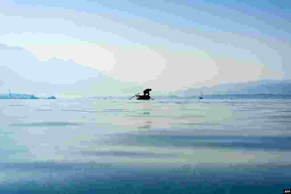 A fisherman checks his catch in the Bay of Kotor near the coastal town of Bijela, Montenegro.