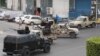 FILE - Tripoli joint security forces on vehicles with heavy artillery stand guard on the entrance road to the parliament area.
