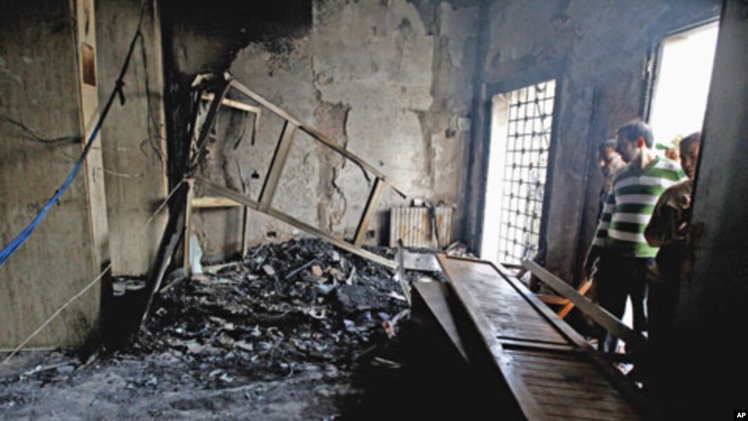 People look at the damage inside a courthouse in Sidi Bouzid, approximately 270 km (168 miles) southwest of the capital Tunis, October 28, 2011.