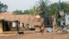 FILE - A goat walks past burned and damaged buildings in Kembong, Southwest region of Cameroon, Dec. 29, 2017.