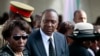 Kenyan President Uhuru Kenyatta joins relatives at burial of his nephew Mbugua Maina and Maina's fiancee Rosemary Wahito, Gatundu village, near Nairobi, Sept. 27, 2013.