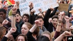 Students raise their fists and shout slogans during a demonstration in Marseille, southern France, March, 9, 2016. 