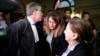 Nathalie Haddadi (C), whose radicalised son fought in Syria where he allegedly died as a jihadist, and her lawyer Herve Denis leave the criminal court in Paris, France, Sept. 28, 2017.