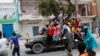 Protesters gather near the scene of Saturday's massive truck bomb attack in Mogadishu, Somalia, Oct. 18, 2017. Thousands of people took to the streets of Somalia's capital in a show of defiance after the country's deadliest attack.