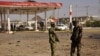 Members of the military stand at the scene of an explosion near a petrol station in Kano, Nigeria, Nov. 15, 2014. 