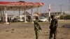 Members of the military stand at the scene of an explosion near a petrol station in Kano, Nigeria, Nov. 15, 2014. 