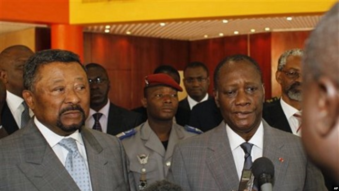Ivory Coast's internationally-recognized President, Alassane Ouattara, right, addresses journalists following a meeting with African Union commission chairman Jean Ping, left, at the Golf Hotel in Abidjan, Ivory Coast, March 5, 2011