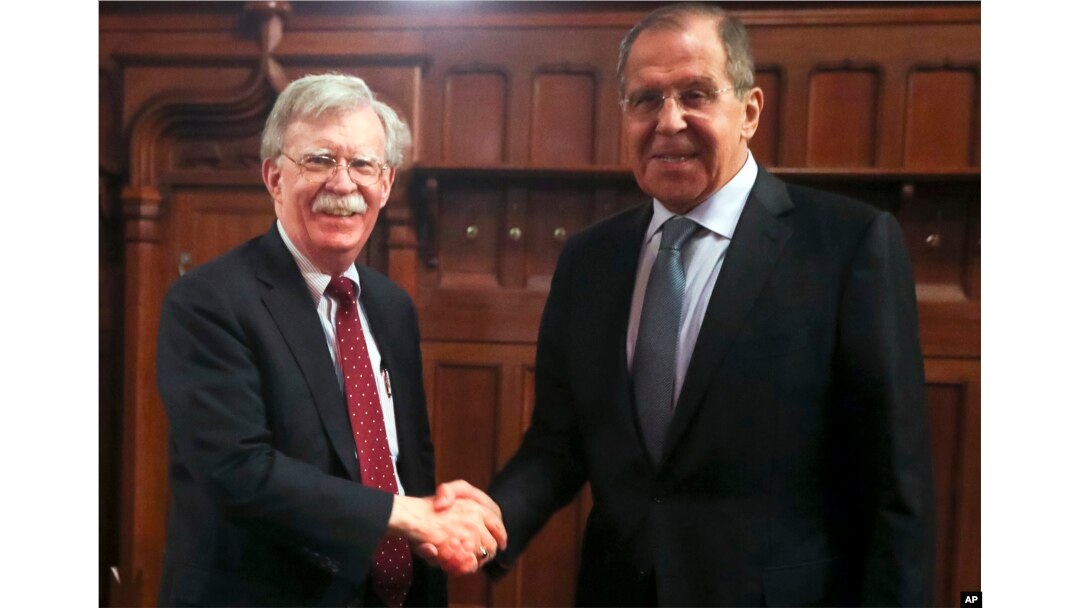 U.S. National Security Adviser John Bolton, left, and Russian Foreign Minister Sergey Lavrov shake hands prior to their talks in Moscow, Oct. 22, 2018.