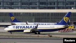 FILE - Two Boeing 737-8AS passenger aircrafts of Ryanair airline taxi on a runway at Malaga-Costa del Sol airport, in Malaga, Spain, May 3, 2024. 