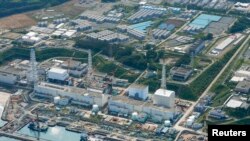 FILE - An aerial view shows the tsunami-crippled Fukushima Daiichi nuclear power plant and its contaminated water storage tanks.