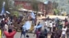 FILE - A still image taken from a video shot on Oct. 1, 2017, shows protesters waving Ambazonian flags in front of road block in the English-speaking city of Bamenda, Cameroon. 