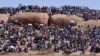 People attend a commemoration service for the striking platinum miners that were killed a year ago, in Marikana, South Africa, August 16, 2013.