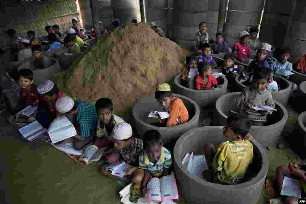 Rohingya refugee children attend recitation classes of the holy Quran in a newly opened madrasa, or religious school, in Balukhali refugee camp, Bangladesh, Oct. 30, 2017.