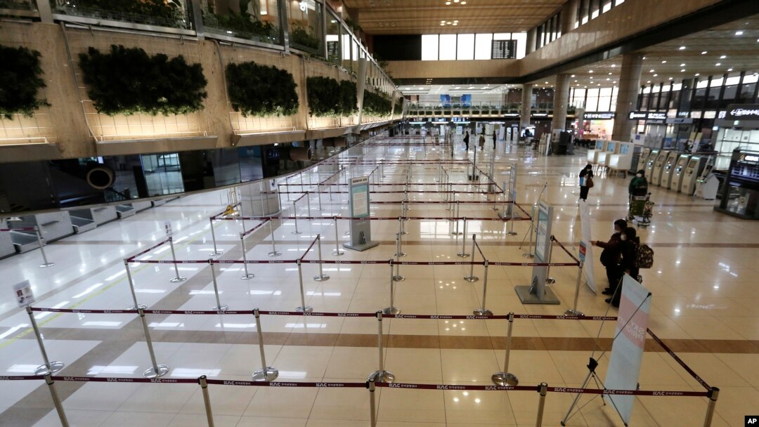 Check-in counters of Japanese airlines are deserted at Gimpo Airport in Seoul, South Korea, Saturday, March 7, 2020. 