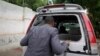 Abdiqadir Dulyar, director for the Somali television station Horn Cable, looks at the smashed window of a car that was carrying journalists working for his station in Mogadishu, May 3, 2016. Unidentified gunmen opened fire on the car last week but no one
was hurt.