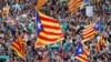 People wave Catalan separatist flags during a demonstration organised by Catalan pro-independence movements ANC and Omnium Cutural, following the imprisonment of their two leaders Jordi Sanchez and Jordi Cuixart, in Barcelona, Oct. 21, 2017.