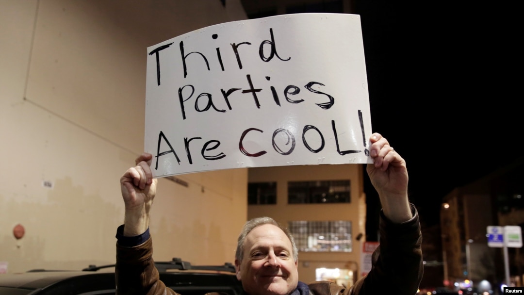 FILE - Libertarian Jeff Jared of Kirkland, Washington, holds a sign in support of third parties in Seattle, Jan. 31, 2019.