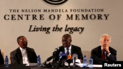 Deputy Chief Justice Dikgang Moseneke (C) reads Mandela's will as he is flanked by Professor Njabulo Ndebele (L) and Advocate George Bizos, Nelson Mandela's lawyer, confidant and friend at the Nelson Mandela Center of Memory in Houghton, Feb. 3, 2014.