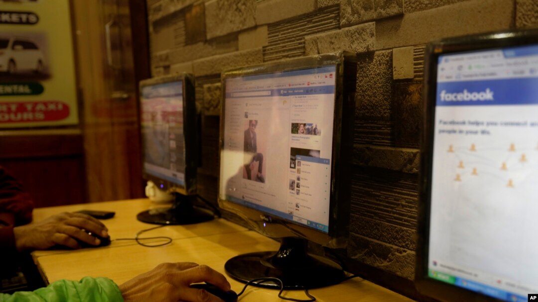 FILE - An Indian man surfs a Facebook page at an Internet cafe in New Delhi, India, Tuesday, Feb. 9, 2016.