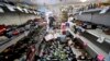 Bottles are strewn in an aisle as Victor Abdullatif mops inside his family's store, July 6, 2019, in Ridgecrest, Calif. The largest quake the region has seen in nearly 20 years jolted an area from Sacramento to Las Vegas to Mexico on Friday.