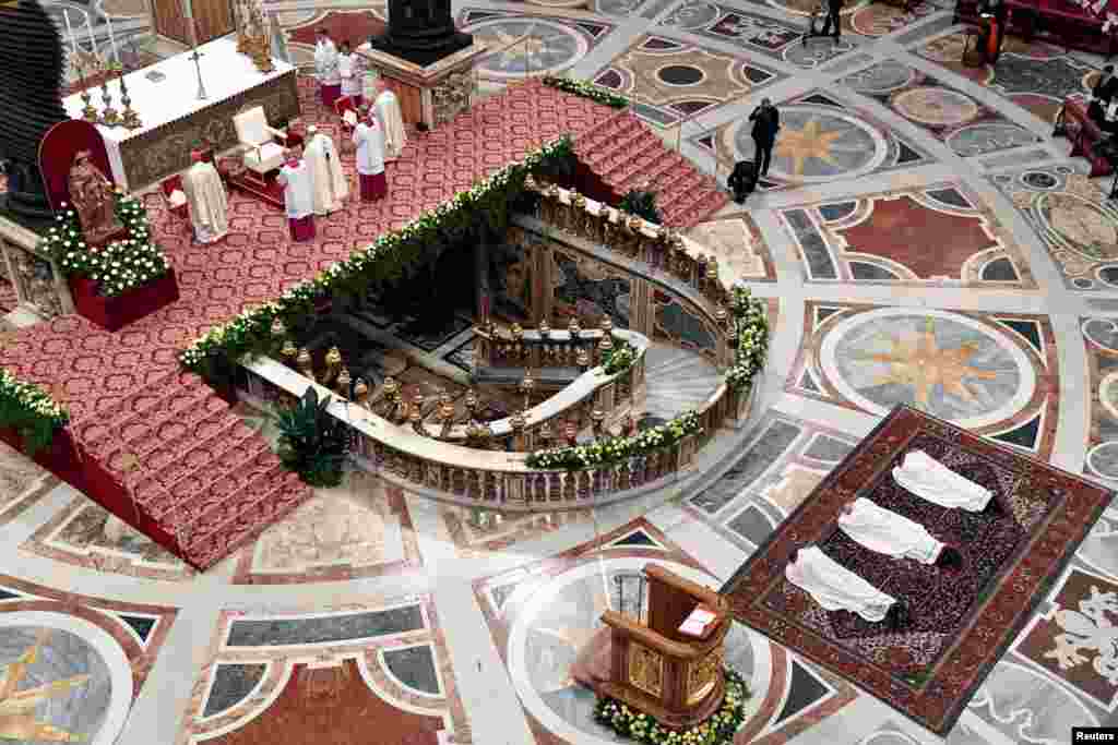 Mons. Waldemar Stanislaw Sommertag, Mons. Alfred Xuereb and Mons. Jose Avelino Bettencourt lie in front of the Altar during their Episcopal Ordination conducted by Pope Francis at Saint Peter's Basilica at the Vatican, March 19, 2018.