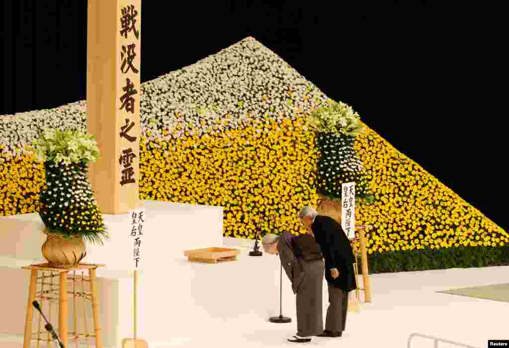 Japan's Emperor Akihito (R) and Empress Michiko bow at an altar for the war dead during a memorial ceremony marking the 72nd anniversary of Japan's surrender in World War II, at Budokan Hall in Tokyo.