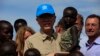 U.N. Secretary-General Ban Ki-moon (C) carries a child displaced by the region's conflict during his visit to an IDP (internally displaced persons) camp in the United Nations Mission in South Sudan (UNMISS) base at Thong Ping in Juba, May 6, 2014.