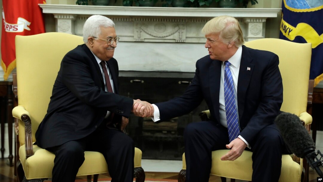 FILE - President Donald Trump shakes hands with with Palestinian leader Mahmoud Abbas during their meeting in the Oval Office of the White House, May 3, 2017, in Washington. 