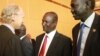Mahaboub Maali, chief negotiator from South Sudan's opposition, center, shakes hands with an unidentified western observer in Addis Ababa, Ethiopia, Jan. 4, 2014.