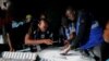Electoral officials count votes during the presidential and parliamentary election at a polling station in Bole, Ghana, Dec. 7, 2024.