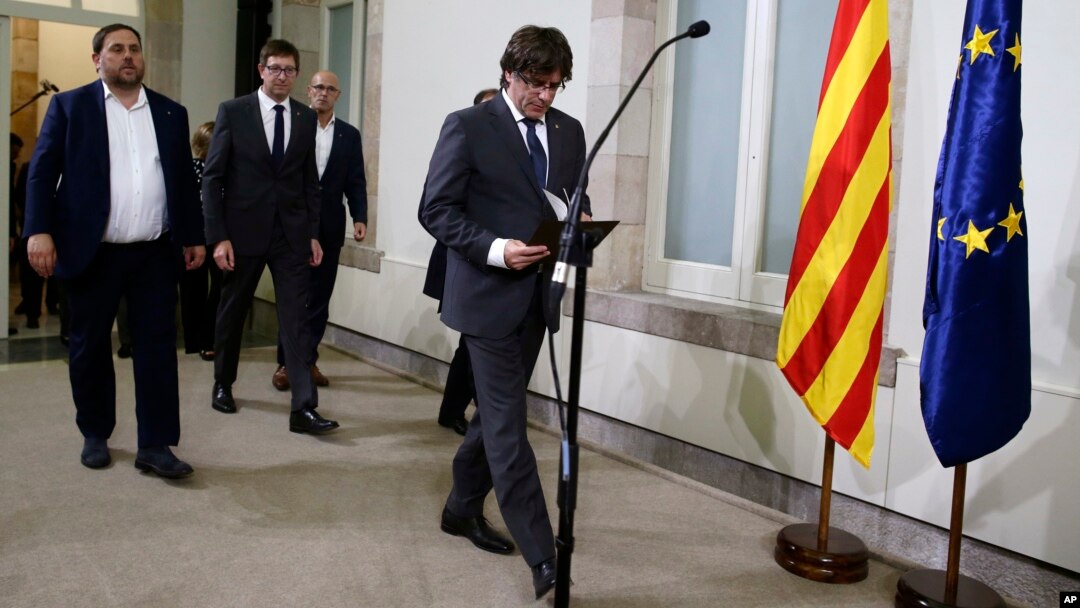 Catalonia regional President Carles Puigdemont arrives for a statement after signing the decree officially calling for the vote on a binding independence referendum, following a plenary session at the Parliament of Catalonia in Barcelona, Spain, Sept. 6, 