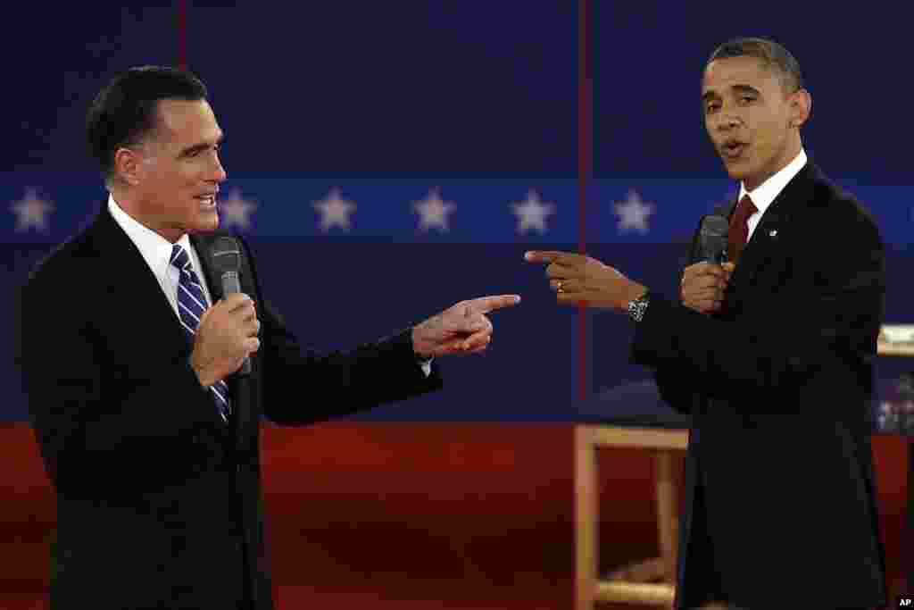 Republican presidential nominee Mitt Romney, left, and President Barack Obama spar during a presidential debate at Hofstra University in Hempstead, New York, Oct. 16, 2012.