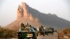 A convoy of Malian troops makes a stop to test their weapons near Hambori, northern Mali, on the road to Gao, February 4, 2013. 