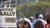 Female residents hold up images of black teenager Trayvon Martin and a packet of Skittles candy during a rally demanding justice for his killing in Miami, Florida April 1, 2012. 