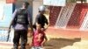 FILE - Policemen detain a protester during clashes in Lubumbashi, Democratic Republic of Congo, Nov. 10, 2015. 