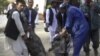 Afghans carry the body of a suicide attack victim at the hospital in Maymana, Faryab province northwest of Kabul, Afghanistan, October 26, 2012.