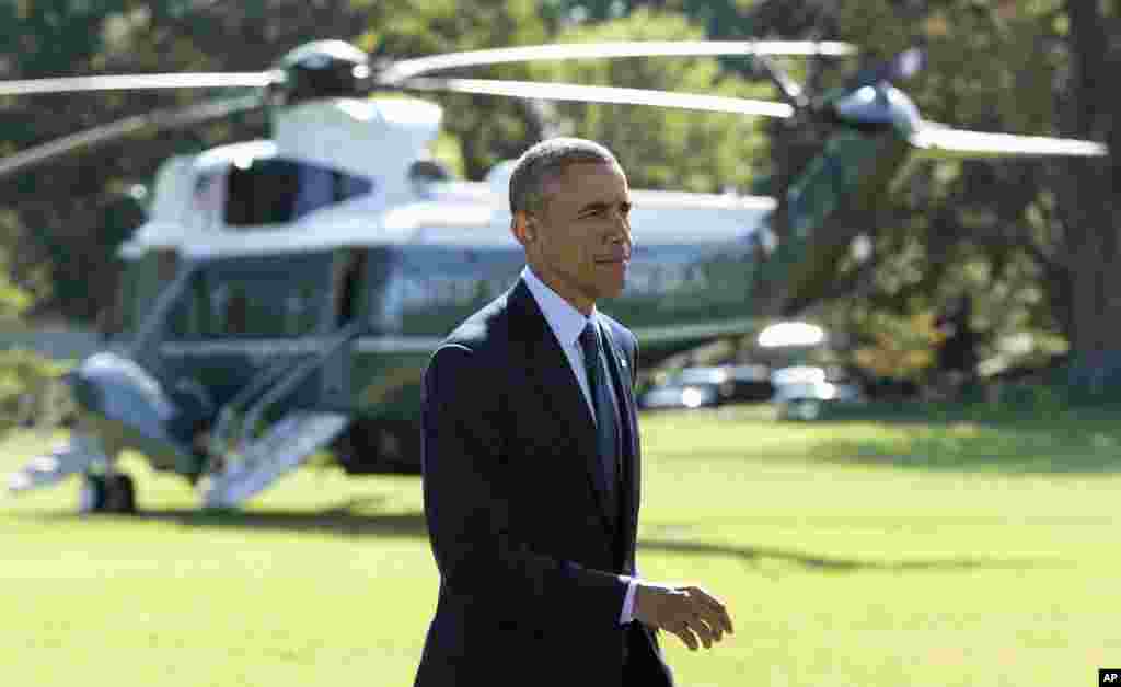 President Barack Obama walks from the podium to the Oval Office of the White House in Washington, Sept. 23, 2014, after speaking about the participation of five Arab nations in airstrikes against militants in Syria.