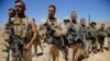FILE - Lebanese soldiers listen to a briefing from an official during a media trip organized by the Lebanese army on the outskirts of Ras Baalbek, northeast Lebanon, Aug. 28, 2017.