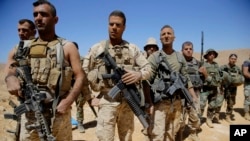 FILE - Lebanese soldiers listen to a briefing from an official during a media trip organized by the Lebanese army on the outskirts of Ras Baalbek, northeast Lebanon, Aug. 28, 2017.