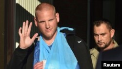 FILE - U.S. serviceman Spencer Stone waves as he departs the Clinique Lille Sud, which specializes in hand injuries, in Lesquin, France, Aug. 22, 2015. 