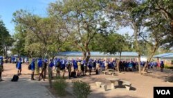 Pupils at a private school in Harare queue for temperature checks before they starts lessons, Nov. 11, 2020. (Columbus Mavhunga/VOA)